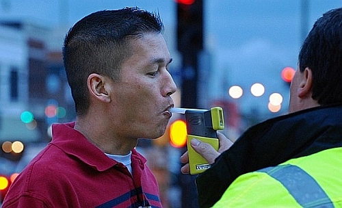 A repeat DUI offender taking a breathalyzer test